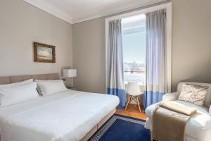 a bedroom with a bed and a chair and a window at Pattini Guest House in Milan