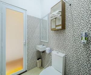 a bathroom with a toilet and a sink at DJourney Hotel Lembang by Escotel in Bandung +60 photos