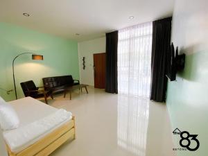 a living room with a bed and a couch at The 83 Betong GuestHouse in Betong +7 photos