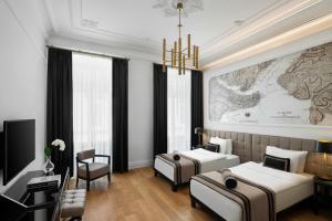 A bed or beds in a room at AKKA Lush Hotel Taksim