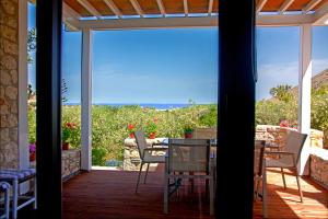 a patio with a view of the ocean from a house at Artemis Village Apartments & Studios in Stavros