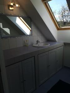 a bathroom with a sink and a window at Vetrovi šumijo II in Kapele