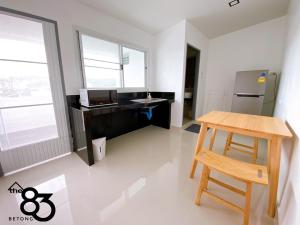 an office with a desk and a wooden chair at The 83 Betong GuestHouse in Betong