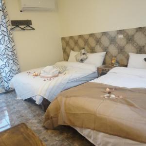 Cama o camas de una habitación en 馬公港精品旅宿包棟烤肉附設租車