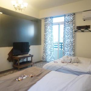 Cama o camas de una habitación en 馬公港精品旅宿包棟烤肉附設租車