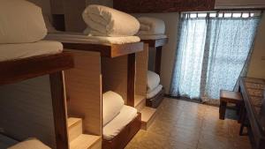 Cama o camas de una habitación en 馬公港精品旅宿包棟烤肉附設租車