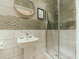 a bathroom with a sink and a shower at Bessemer House Apartments in Attercliffe