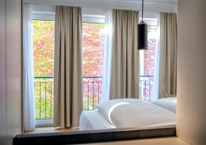 Katil atau katil-katil dalam bilik di Boutique Hotel Hauser