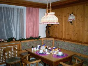 a dining room with a wooden table and chairs at Haus Lattacher by Châtel Reizen in Stuben am Arlberg
