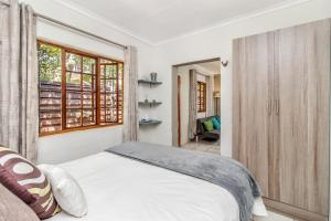 a bedroom with a bed and a window at Villa Roma - Luxury Accommodation in Centurion