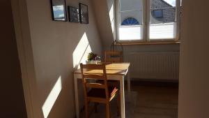 a table and chair in a room with windows at Ferienwohnung Zellner in Deggendorf +27 photos