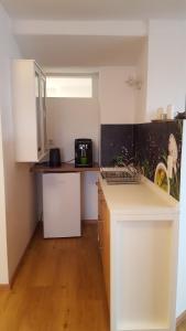 a kitchen with white cabinets and a counter top at Ferienwohnung Zellner in Deggendorf