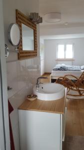 een badkamer met een wastafel en een bed bij Ferienwohnung Zellner in Deggendorf