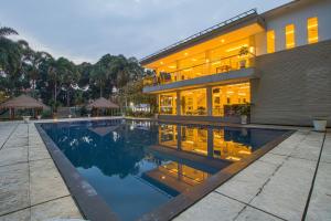 a house with a swimming pool in front of it at Sheo Resort Hotel in Bandung