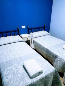 Postel nebo postele na pokoji v ubytování APARTAMENTOS LOS ÁLAMOS