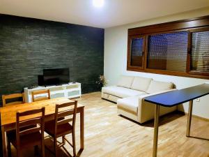 a living room with a couch and a table at APARTAMENTOS LOS ÁLAMOS in Abadía