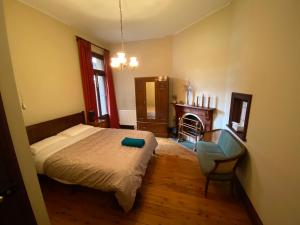 a bedroom with a bed and a chair and a desk at Yass Central Bed & Breakfast in Yass