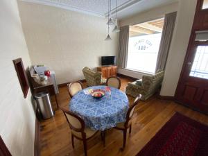 a dining room with a table and chairs and a room at Yass Central Bed & Breakfast in Yass