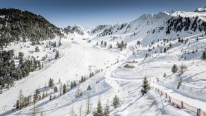 a snow covered mountain with a ski slope at Hotel Ritzlerhof - Panorama und Spa in Sautens