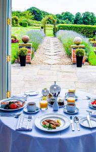 a table with a blue table cloth with food on it at Dovecliff Hall Hotel in Burton upon Trent