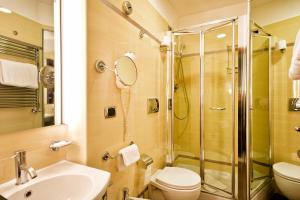 a bathroom with a shower and a toilet and a sink at Hotel Sonya in Rome +30 photos