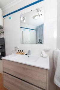 a bathroom with a sink and a mirror at HomeForGuest Spacious and bright flat on the beach La Tejita in Granadilla de Abona