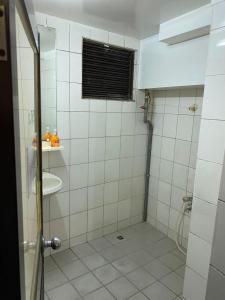 a bathroom with a shower and a sink at Guang Haw Hotel in Tainan