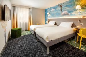 מיטה או מיטות בחדר ב-ibis Styles Manchester Portland