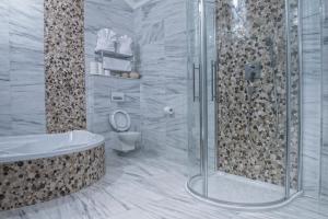 a bathroom with a shower and a toilet and a tub at Mountain Resort Residences in Ždiar