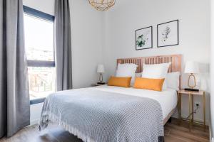 Łóżko lub łóżka w pokoju w obiekcie Feelathome Goya Apartments