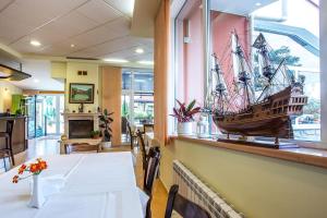 a dining room with a pirate ship on the wall at Family Hotel Saint Konstantin in Glavatartsi