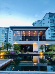 a large building with a pool in front of it at The Quintet Condominium 3-1 in Tanah Rata