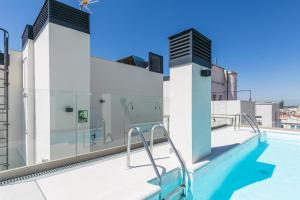 a swimming pool on the roof of a building at Feelathome Goya Apartments in Madrid