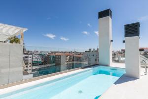 a swimming pool on the roof of a building at Feelathome Goya Apartments in Madrid