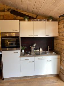 a kitchen with white cabinets and a sink at Willow Court Farm Studio East & Petting Farm, 8 mins to Legoland & Windsor, 15 mins to Lapland UK in Windsor +37 photos