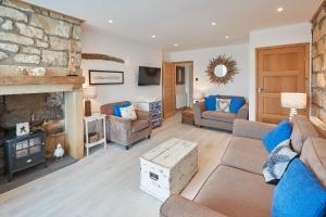 a living room with a couch and a fireplace at Host & Stay - The Cottage, Marske in Marske-by-the-Sea