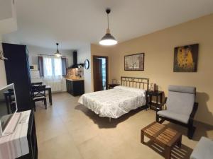 1 dormitorio con 1 cama, mesa y sillas en Complejo Apartamentos Rurales Molino de Abajo, en Ribera Baja