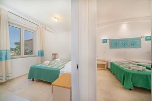Postel nebo postele na pokoji v ubytování Hotel Le Mimose