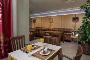 a dining room with tables and chairs and drinks at Hotel Podstine in Hvar