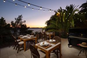 a restaurant with tables and a piano on a patio at Hotel Podstine in Hvar