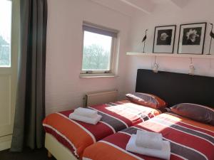Postel nebo postele na pokoji v ubytování Vacation home Zwaantje #ABB24