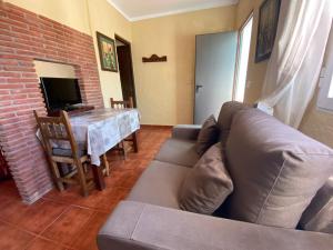 a living room with a couch and a table at Hostal Restaurante El Cruce in Ardales