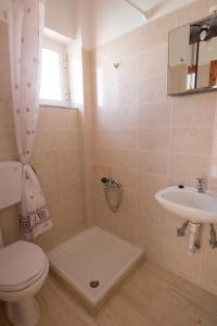 a bathroom with a toilet and a sink at Elena Rooms & Apartments in Gerani Chanion