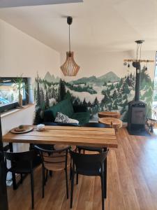 a living room with a table and a couch at Bieszczadzkie BOHO stodoły z jacuzzi i sauna na wyłączność in Myczkowce