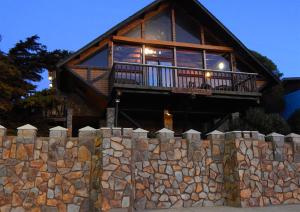 a stone wall in front of a house at Hotel Boutique Castillo del Mar in El Quisco