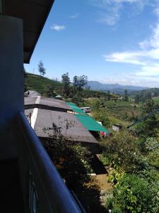a view from a balcony of a building with a hill in the background at Cool Mount Guest in Nuwara Eliya