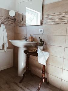 a bathroom with a sink and a mirror at La casetta al maneggio in Catania