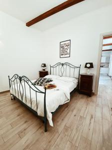 a bedroom with a bed and a wooden floor at La casetta al maneggio in Catania +27 photos