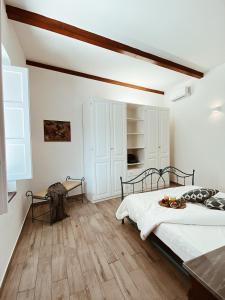 a bedroom with a bed and a wooden floor at La casetta al maneggio in Catania