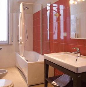 a bathroom with a shower and a sink and a toilet at Hotel Terme in Monticelli Terme